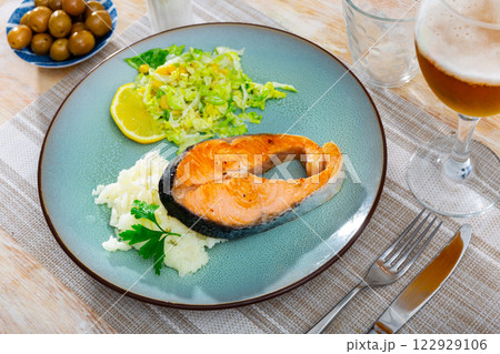 Salmon served with potatoes and salad 122929106