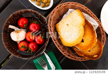 Traditional Spanish snack, Pa amb tomaquet, served o wooden table 122929149