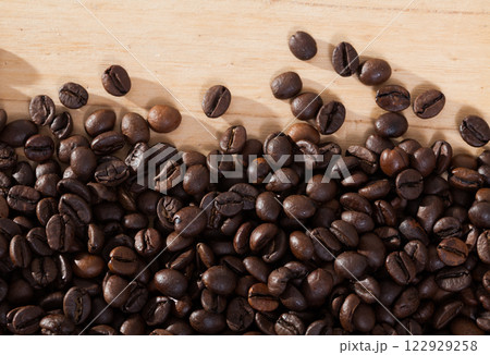 Image of fresh coffee beans on natural wooden background 122929258