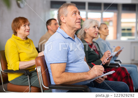 Group of mature students attending lecture in college Group of mature students attending lecture in college 122929292