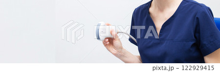 Female doctor in a hospital with ultrasound scanning diagnostic Female doctor in a hospital with ultrasound scanning diagnostic 122929415