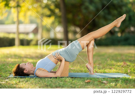 Adult woman doing yoga with blocks Adult woman doing yoga with blocks 122929772