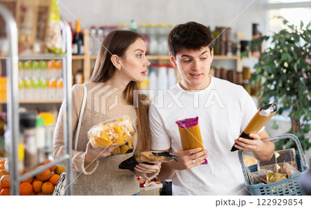 Couple young man and woman choosing pasta Couple young man and woman choosing pasta 122929854