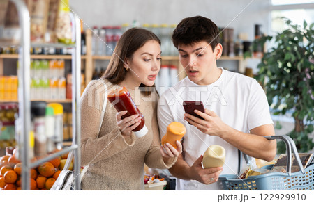 Couple man and woman scanning qr code for sauces 122929910