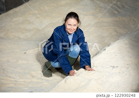 Farmer holding corn flour in hand. Heap of animal feed Farmer holding corn flour in hand. Heap of animal feed 122930248