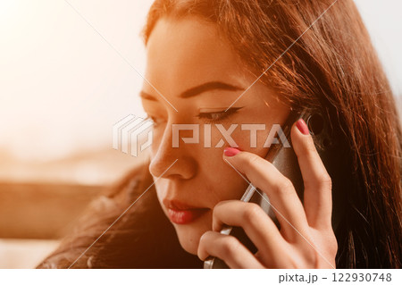 Woman Phone Call Closeup Portrait - Closeup portrait of a young woman talking on her phone. 122930748