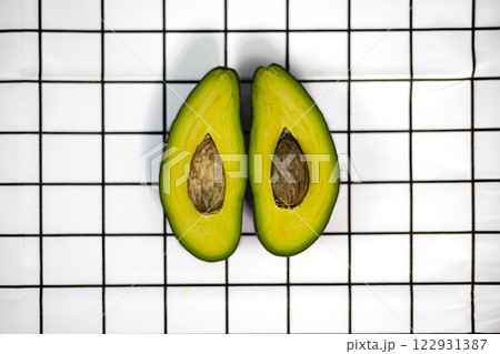 Fresh avocado cut in haft on the table. Juicy ripe avocado. 122931387