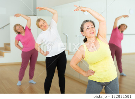 Mature women training at group dance class Mature women training at group dance class 122931591