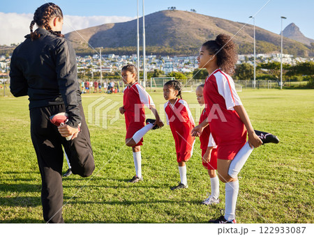 Soccer, team and stretching girl with coach on a sport field while training, exercise or practice together. Teamwork, collaboration and motivation with football group with fitness workout before game 122933087