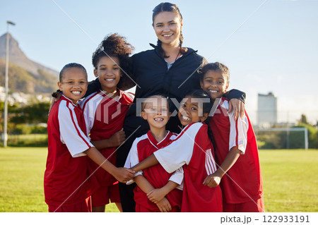 Football, happy and girl team with coach on a sport soccer field after training or a game. Teamwork and collaboration with a happy group of female athletes play for fun, to win and succeed 122933191