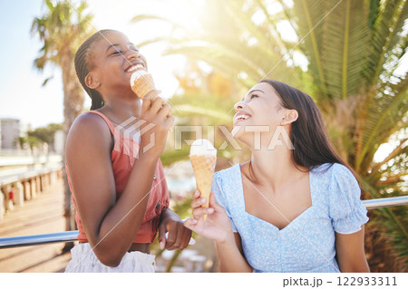 Ice cream, summer and women friends eating on Miami beach for holiday travel, vacation and outdoor youth lifestyle with sunshine lens flare. Happy, diversity teenager couple with icecream dessert Ice cream, summer and women friends eating on Miami beach for holiday travel, vacation and outdoor youth lifestyle with sunshine lens flare. Happy, diversity teenager couple with icecream dessert 122933311