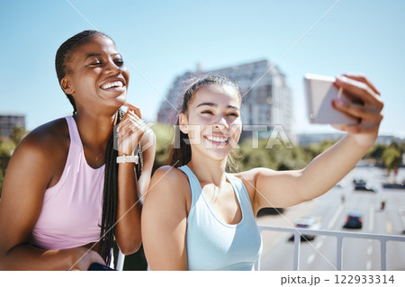 Phone, exercise and friends taking a selfie after a workout or yoga training session outdoor. Happy smile women enjoying fresh air and fitness, excited and bonding with wellness and health in a city 122933314