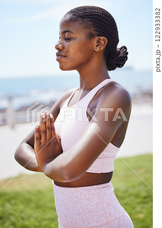 Nature yoga, meditation and black woman praying for spiritual wellness on the grass in the city of San Francisco. Calm, happy and young African girl doing zen exercise for mind health in a park 122933382
