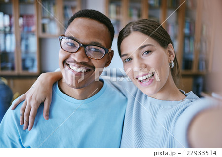 University students and library friends selfie smile together in education literature centre. Happy, cheerful and optimistic interracial college friendship photograph in educational campus. University students and library friends selfie smile together in education literature centre. Happy, cheerful and optimistic interracial college friendship photograph in educational campus. 122933514