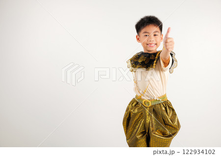 Portrait Thailand kid boy smiling traditional Thai dress costume makes thumbs up OK sign, symbolizing agreement, studio isolated white background, primary child radiates positivity and satisfaction Portrait Thailand kid boy smiling traditional Thai dress costume makes thumbs up OK sign, symbolizing agreement, studio isolated white background, primary child radiates positivity and satisfaction 122934102