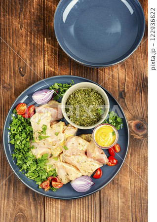 Raw marinated chicken meat cilantro herb. 122936822