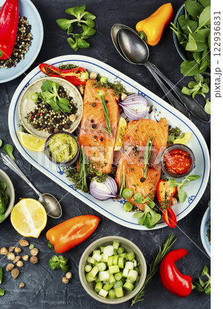 Raw salmon fish and ingredients for cooking and seasoning Raw salmon fish and ingredients for cooking and seasoning 122936831