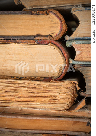 Textured stack of old books close up. Close up of old paper pages of book. 122939171