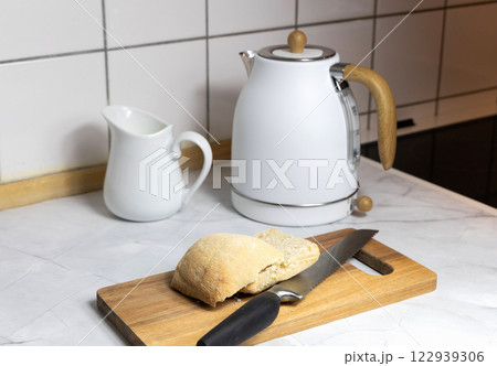 Breakfast served on the kitchen table with fresh bread and coffee Breakfast served on the kitchen table with fresh bread and coffee 122939306