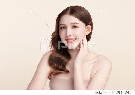 Beautiful young asian woman with clean fresh skin on beige background, Face care, Facial treatment, Cosmetology, beauty and spa, Asian women portrait. 122941249