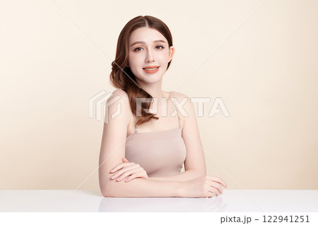 Beautiful young asian woman with clean fresh skin on beige background, Face care, Facial treatment, Cosmetology, beauty and spa, Asian women portrait. Beautiful young asian woman with clean fresh skin on beige background, Face care, Facial treatment, Cosmetology, beauty and spa, Asian women portrait. 122941251