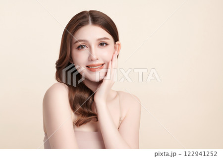 Beautiful young asian woman with clean fresh skin on beige background, Face care, Facial treatment, Cosmetology, beauty and spa, Asian women portrait. Beautiful young asian woman with clean fresh skin on beige background, Face care, Facial treatment, Cosmetology, beauty and spa, Asian women portrait. 122941252