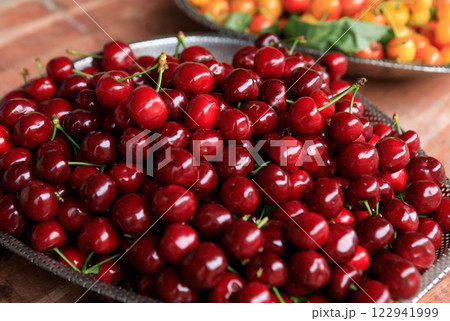 Fesh red cherry fruits in a container 122941999