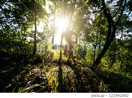 Woman runner running on forest trail 122942002