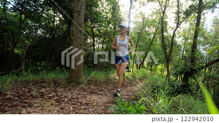 Woman runner running on forest trail 122942010
