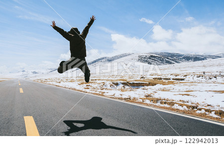 People jumping on snowy country road People jumping on snowy country road 122942013