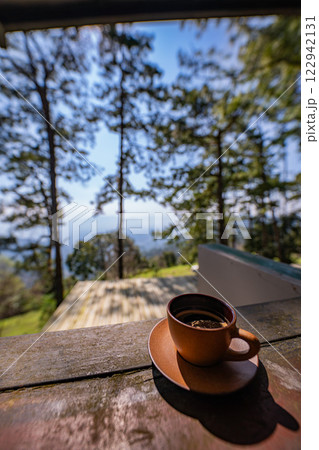 A small cup of coffee in a big forest 122942131