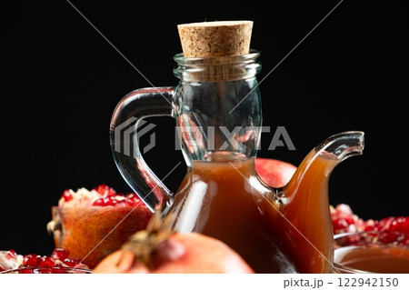 Natural Traditional Pomegranate Vinegar in Vinegar Cruet on Black Background 122942150