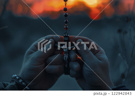 Cross in hands against the backdrop of sunset.Generative AI 122942843