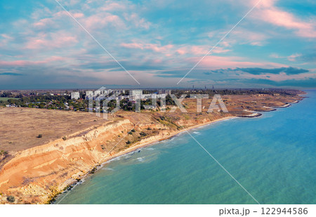 Seascape with sea and city on the clay steep coast. Aerial view of Chornomorske, Odesa, Ukraine Seascape with sea and city on the clay steep coast. Aerial view of Chornomorske, Odesa, Ukraine 122944586