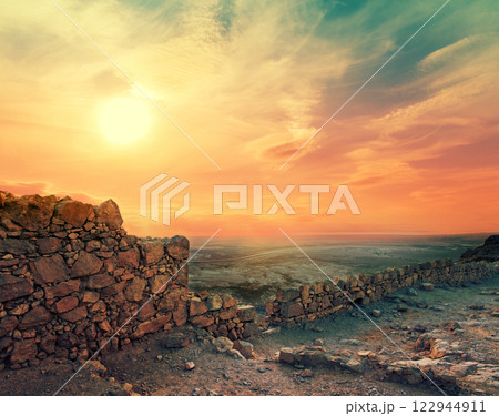 Beautiful purple sunrise over Masada fortress. Ruins of King Herod's palace in Judaean Desert. Beautiful purple sunrise over Masada fortress. Ruins of King Herod's palace in Judaean Desert. 122944911