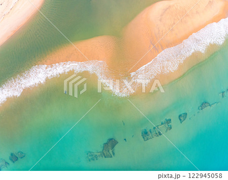 Summer seascape beautiful waves,Tropical sea water in sunny day, Top view from drone camera,Amazing ocean colorful nature background, Beautiful bright sea waves splashing on beach sand 122945058