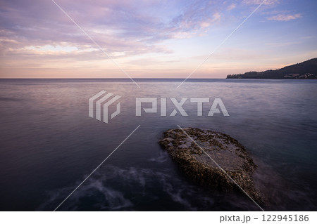 Long exposure image of Dramatic sky seascape with rock in sunset scenery background Long exposure image of Dramatic sky seascape with rock in sunset scenery background 122945186