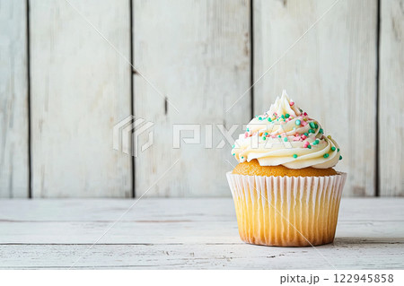 delicious cupcake with white cream on white wood. Copy space delicious cupcake with white cream on white wood. Copy space 122945858