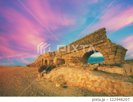 Seascape during sunset. Old aqueduct in Caesarea, Israel 122946207