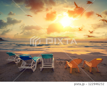 Seascape in the evening. Beach in the evening with chaise lounges 122946232