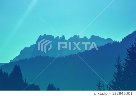 Silhouette of mountains. Mountain landscape in the evening. The Dolomites Alps against the sunset sky. Sella Pass, Grohmannspitze, Selva di Val Gardena, Bolzano, Italy 122946301