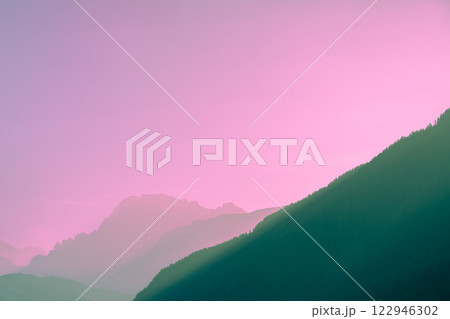 Silhouette of mountains against the pink sunset sky 122946302