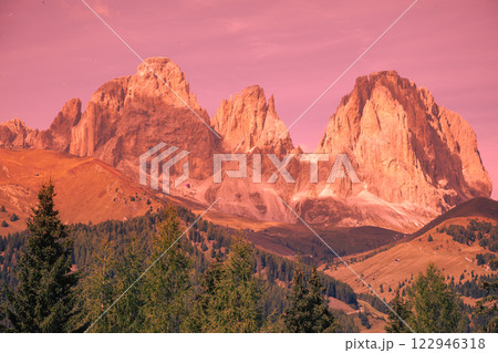 Mountain landscape in the evening. The Dolomites Alps against the sunset sky. Sella Pass, Grohmannspitze, Selva di Val Gardena, Bolzano, Italy Mountain landscape in the evening. The Dolomites Alps against the sunset sky. Sella Pass, Grohmannspitze, Selva di Val Gardena, Bolzano, Italy 122946318