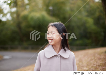冬の朝の公園で元気で楽しく遊んでいる小学生の女の子の様子 冬の朝の公園で元気で楽しく遊んでいる小学生の女の子の様子 122946357