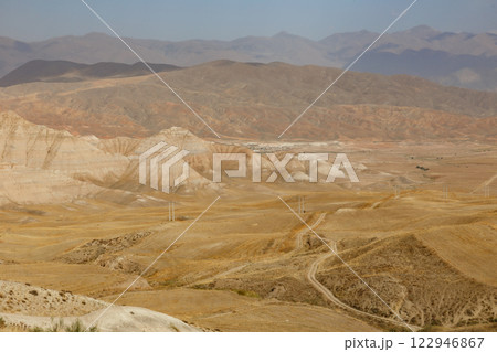Arid Iranian landscape with unique geological formations and mountains Arid Iranian landscape with unique geological formations and mountains 122946867