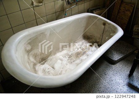 Old dirty bathtub showing neglect and abandonment in a bathroom 122947248