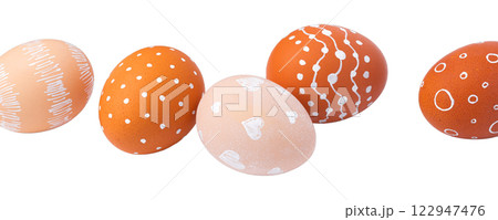 Natural brown Easter eggs with white minimalist patterns (hearts, dots, and lines) 122947476