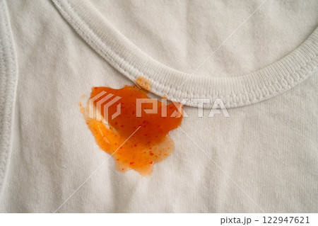 Dirty tomato sauce stain removal or ketchup on cloth accident to wash with washing powder, cleaning housework. Dirty tomato sauce stain removal or ketchup on cloth accident to wash with washing powder, cleaning housework. 122947621