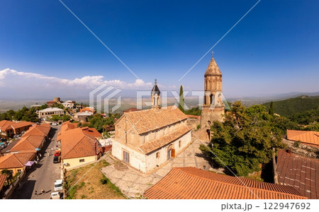 Aerial view on St. George's Church and Alazani valley, Georgia, Kakheti region, Signagi village. Sighnaghi city of love on hill near Gombori Range. Drone Photography in sunny summer day. Aerial view on St. George's Church and Alazani valley, Georgia, Kakheti region, Signagi village. Sighnaghi city of love on hill near Gombori Range. Drone Photography in sunny summer day. 122947692