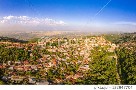Aerial view on St. George's Church and Alazani valley, Georgia, Kakheti region, Signagi village. Sighnaghi city of love on hill near Gombori Range. Drone Photography in sunny summer day. 122947704